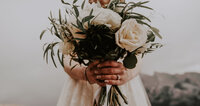 wedding florals being held by a bride.