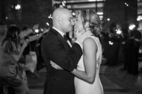 Sparkler exit kiss between new husband and wife
