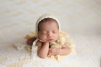Newborn baby girl in a froggy pose during her studio session at Jennifer Brandes Photography in New Ulm, MN.