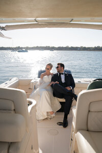 Bride and Groom on a boat riding t their reception in Beaufort,SC