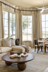 daley home sunny bell new construction sitting room with large windows and coffee table