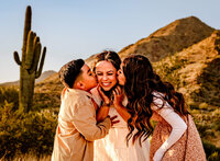 Az kids kissing mom's cheeks during photo session in Phoenix