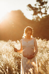 Maternity session in a wildflowers field at golden hour in Christchurch