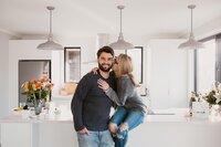 aimee kelly and her husband sitting in her kitchen in new plymouth