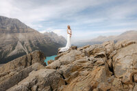 Bride shown standing tall at peyto lake with the majestic canadian rockies in the background.