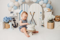 Baby celebrates his first birthday with a Cake Smash Portrait Session at Holy City Babies Portrait Studio in Charleston, SC.