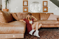 woman posing in front of a couch