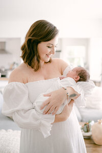 Mom smiling at newborn baby lifestyle newborn photographer South Florida