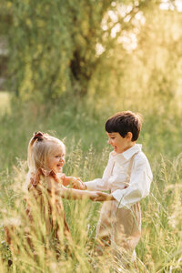 girl and boy playing in field