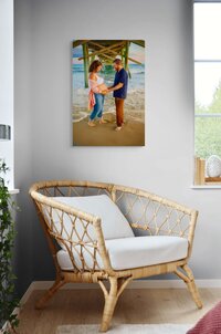 Large canvas wall art featuring a beach maternity portrait displayed in a light filled home