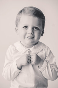 Heirloom Photographer in Charleston - Baby looks at the camera during Heirloom Photoshoot at Holy City Babies Portrait Studio in Charleston, SC.