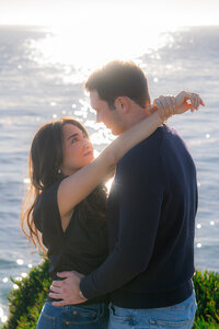 Sunset sparkling ocean couple engagement photos on santa cruz cliffside