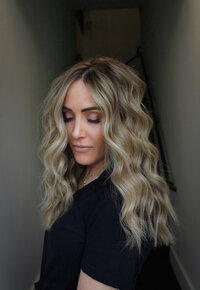 Side profile of a woman with ash blonde wavy hair