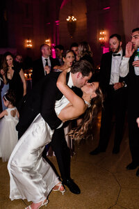 Newlyweds kiss on the dance floor of the DC reception