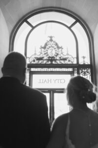 san francisco city hall wedding exit with city hall sign