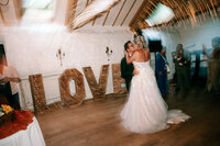colourful candid wedding photography at Bickley mill Devon capturing bride and grooms first dance