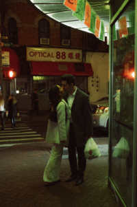 A couple kissing in the middle of Chinatown