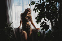 woman leaning on a window laughing silhouette