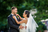 bride and groom on wedding day laughing together in a natural moment