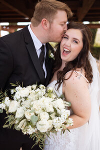 Close-up of the bride holding her white rose bouquet