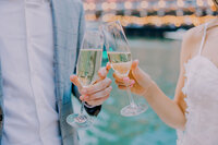 champagne flutes toasting by the riverwalk in Chicago during the engagement session