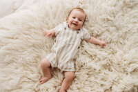 Charleston Baby Milestone Photographer - Baby posed in a tiny baby bed for Studio Milestone Portraits in Charleston, SC