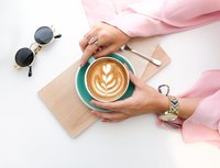 Flatlay of woman holding coffee cup
