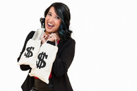 photo of a business coach holding  props with money sign to represent her business