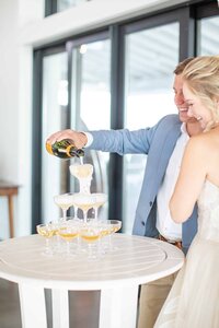 Bride and Groom pouring champagne in their champagne tower