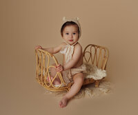 baby sitting with props during luxury milestone portrait session at CG Photography