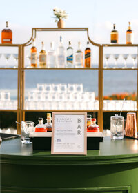 Styled bar area photographed at a brand event, showcasing signage, product placement, and guest experience