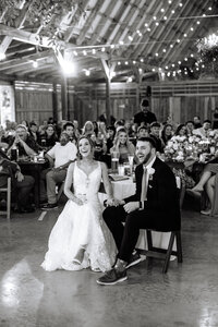 Bride and Groom laugh with guests during toast at wedding reception in Knoxville