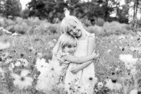 Sibling hugging and smiling at the camera during Family session in Bend Oregon
