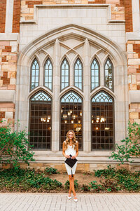 Vanderbilt tower senior wearing white dress and holding cap