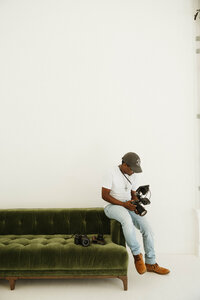 Kendrick sitting with his wedding photography camera gear
