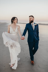 bride and groom walking down hilton head beach