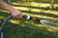 man-watering-his-plants-his-garden-man-blue-shirt