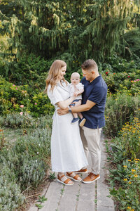 A sweet family moment captured during a morning family photo session at Alexander Muir Memorial Gardens in Toronto