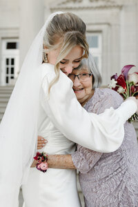 Bride hugs her grandma on her wedding day