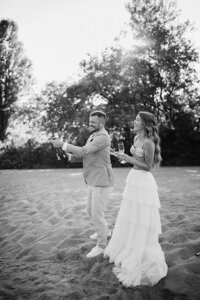 Popping champagne on the beach during a wedding