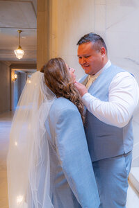 bride with grooms jacket at san francisco city hall wedding