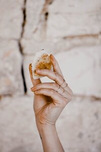 Hand holding a white stone