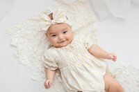 Baby girl during her four month milestone photography session at Jennifer Brandes Photography, in South Central Minnesota.