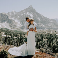Couple embracing at marvel pass during their helicopter elopement