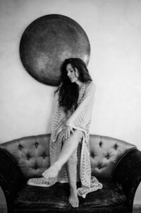 Boudoir experience whilst travelling woman wearing kimono seated on sofa