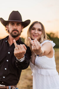 Candid moment of a couple sharing a laugh during a DFW engagement session by Graceful Ray Photography.
