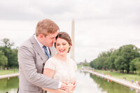 A wedding photo of a couple in front of the Washington Monument in Washington D.C.