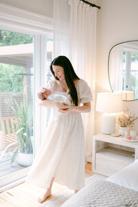 Mom rocking her baby at home during Miami newborn photoshoot