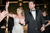 Bride and groom dancing and celebrating at their reception captured in Detroit wedding photography