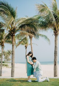 Happy couple embracing under swaying palm trees, symbolizing love, romance, and tropical escapes.